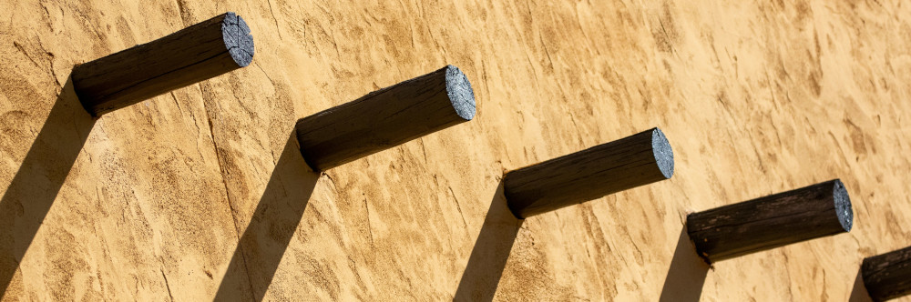 On the Inventional of the Mechanical Pencil or Why I Did Not Quit Today by Zary Fekete A row of wooden pegs on a wall, photo by Dulcey Lima