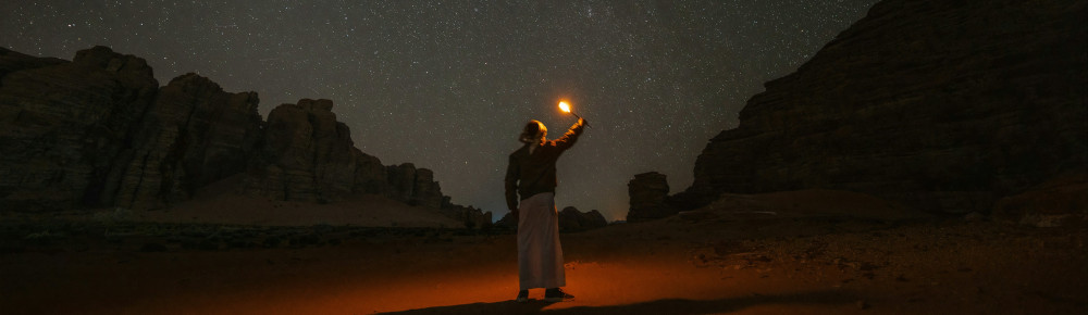 Are You Receiving Me? by Robin Shepard A person holding a light, photo by Neom