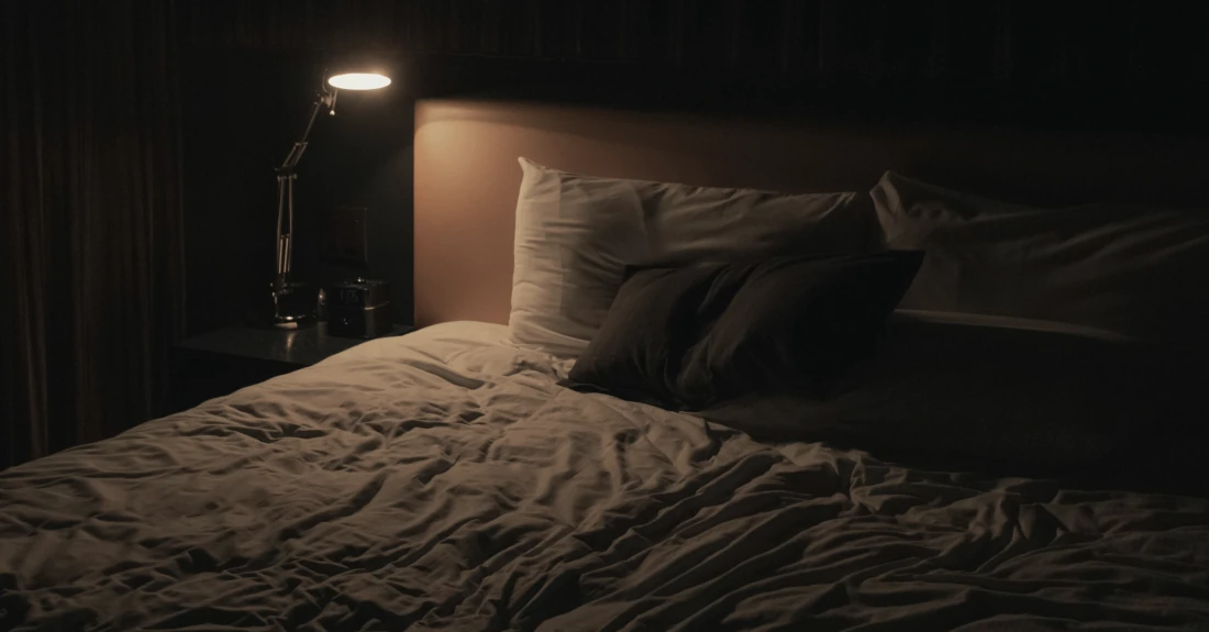 A bed in a bedroom, photo by JP Valery