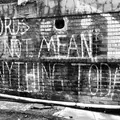 A brick wall with graffiti, photo by Hennie Stander