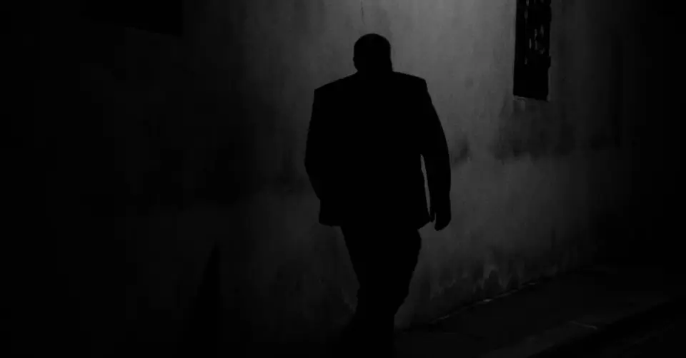 Silhouette of a man walking at night, photo by Rene Bohmer