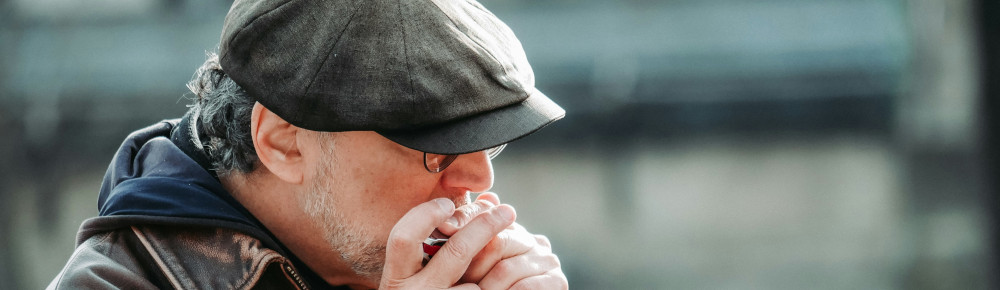 Man playing harmonica, photo by Matt Seymour